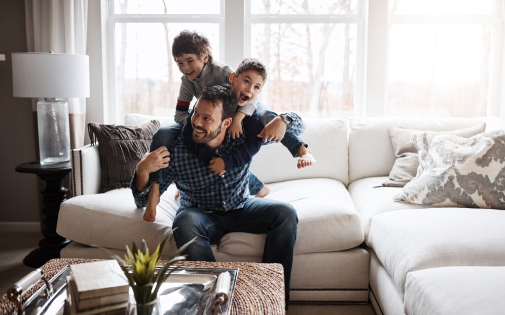 Young family enjoying financial confidence at home through long-term planning