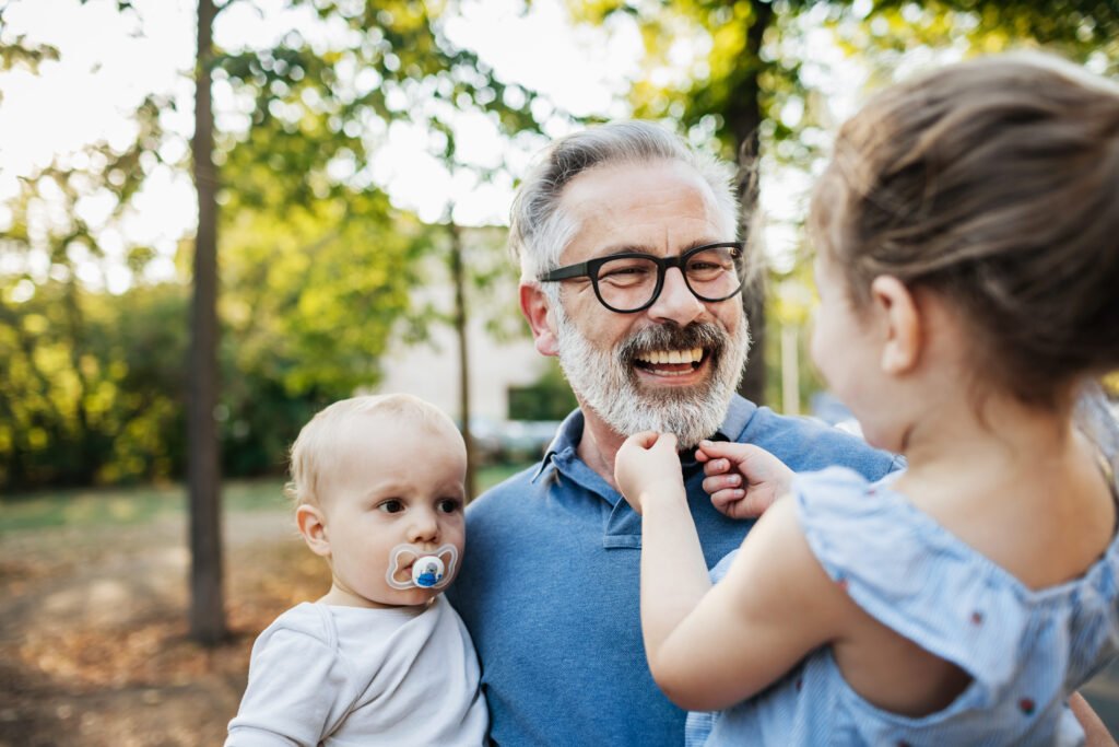 Grandfather spending time with grandchildren after successful retirement planning